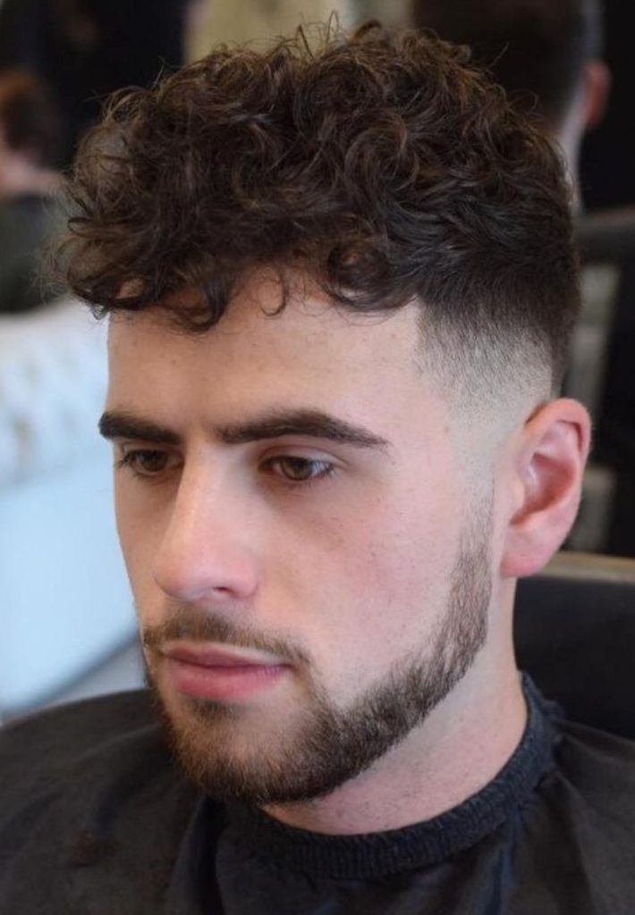 a young man with chin curtain beard