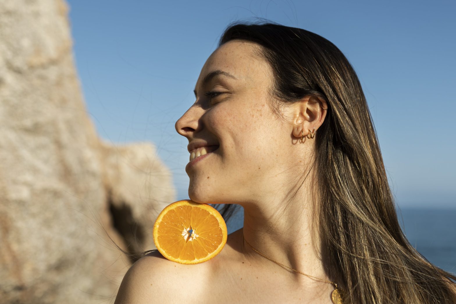 Girl with glowing skin holding fresh fruits