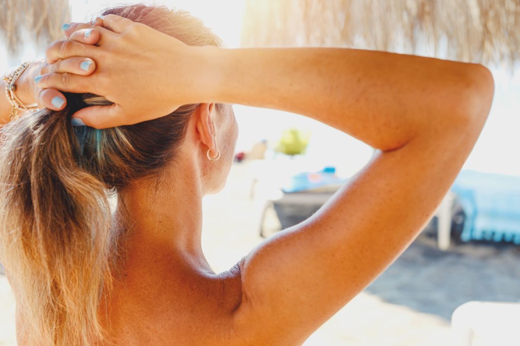 a girl shows their tanning skin
